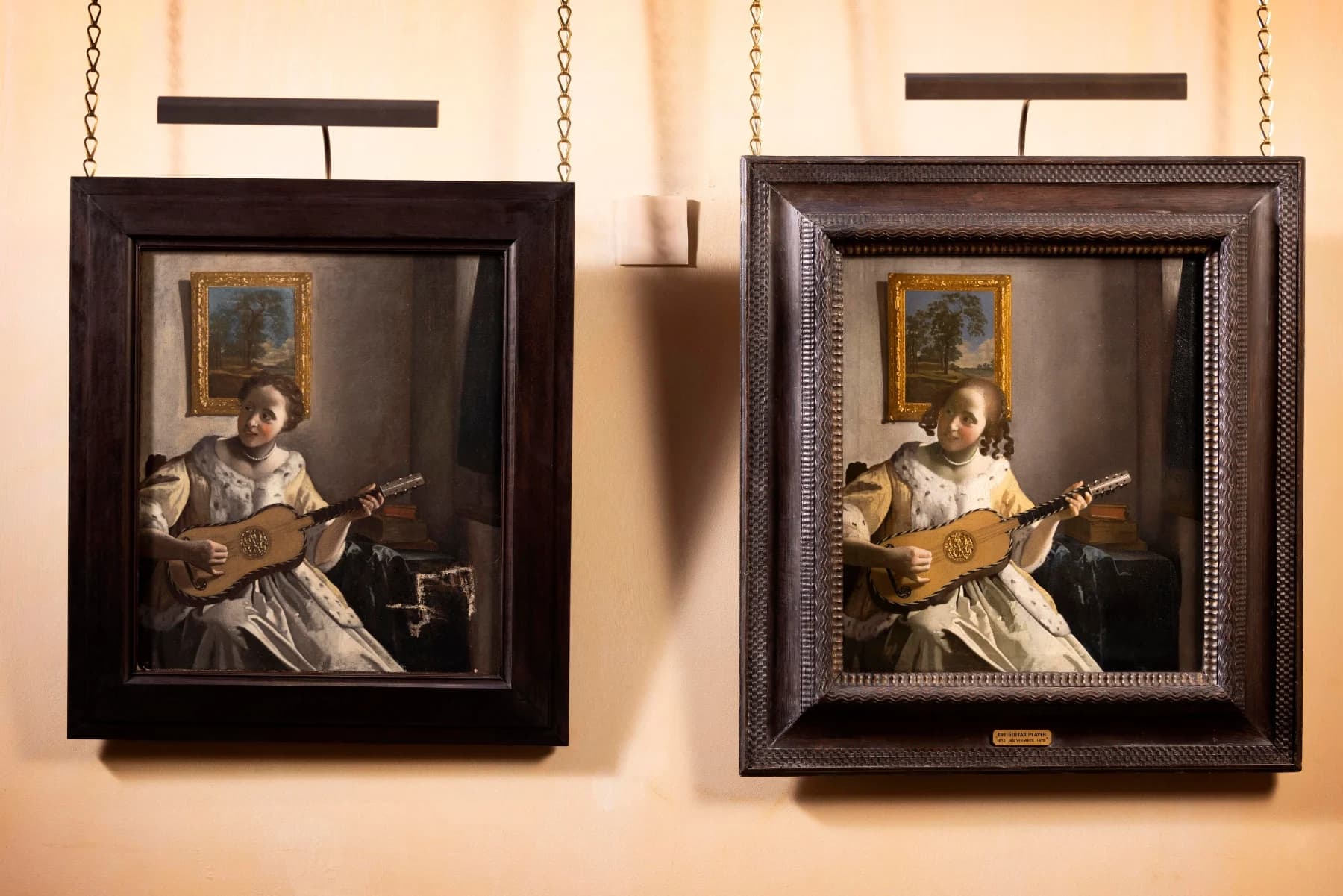 Installation view of Double Vision at Kenwood: the two near-identical versions of The Guitar Player hung side by side on a pale wall and lit from above, the Philadelphia painting on the left and Kenwood's signed Vermeer in its ornate dark frame on the right.
