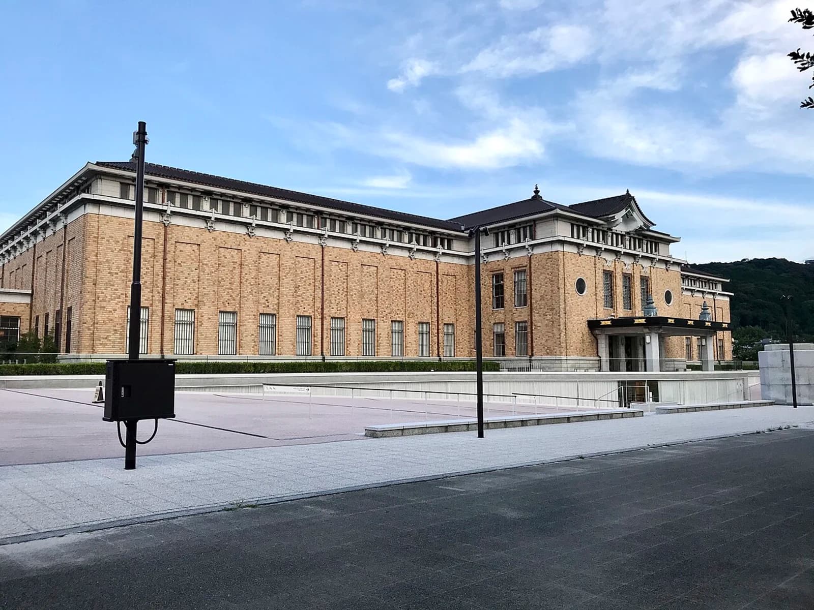 Daytime exterior view of the Kyoto City Kyocera Museum of Art (formerly Kyoto Municipal Museum of Art) in Okazaki Park, showing the renovated building facade