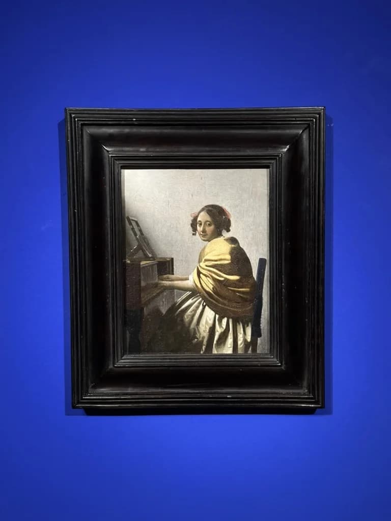 A Vermeer painting on the exhibition's deep blue walls at the Nakanoshima Museum of Art