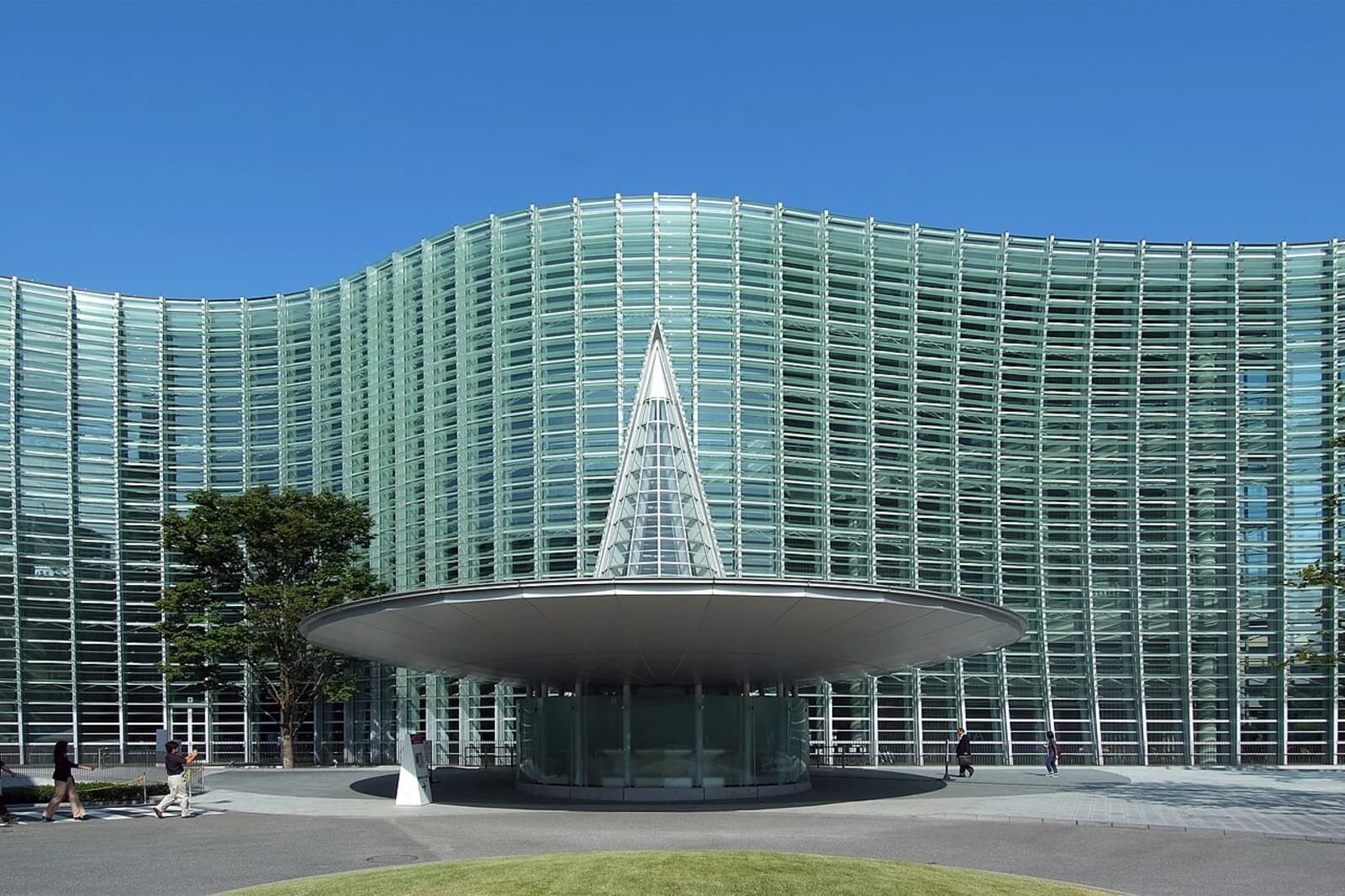 Exterior of the National Art Center, Tokyo, showing the distinctive undulating glass facade designed by architect Kisho Kurokawa