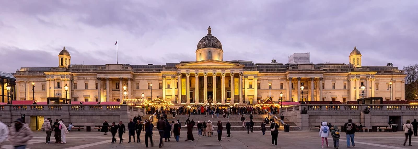 Panoramic view of the front facade of the National Gallery on Trafalgar Square, London, showing the neoclassical portico and dome