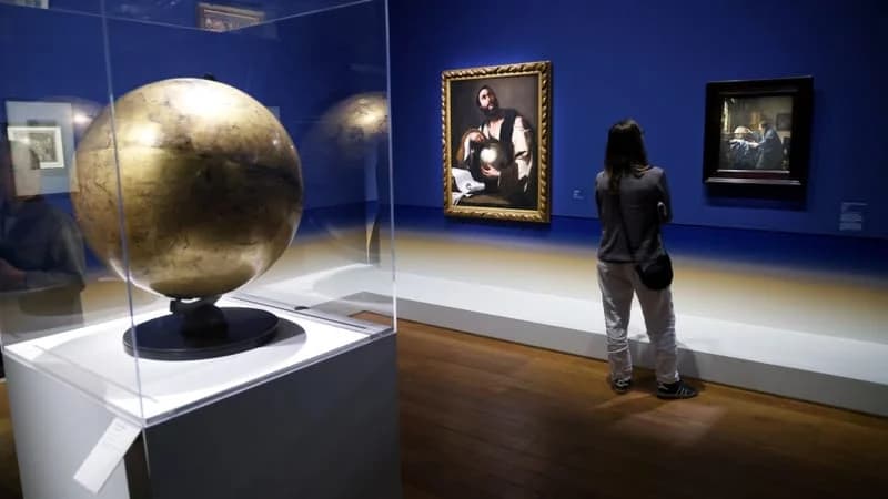 Installation view at the MuCEM showing Vermeer's The Astronomer on loan from the Louvre, with a celestial globe in the foreground