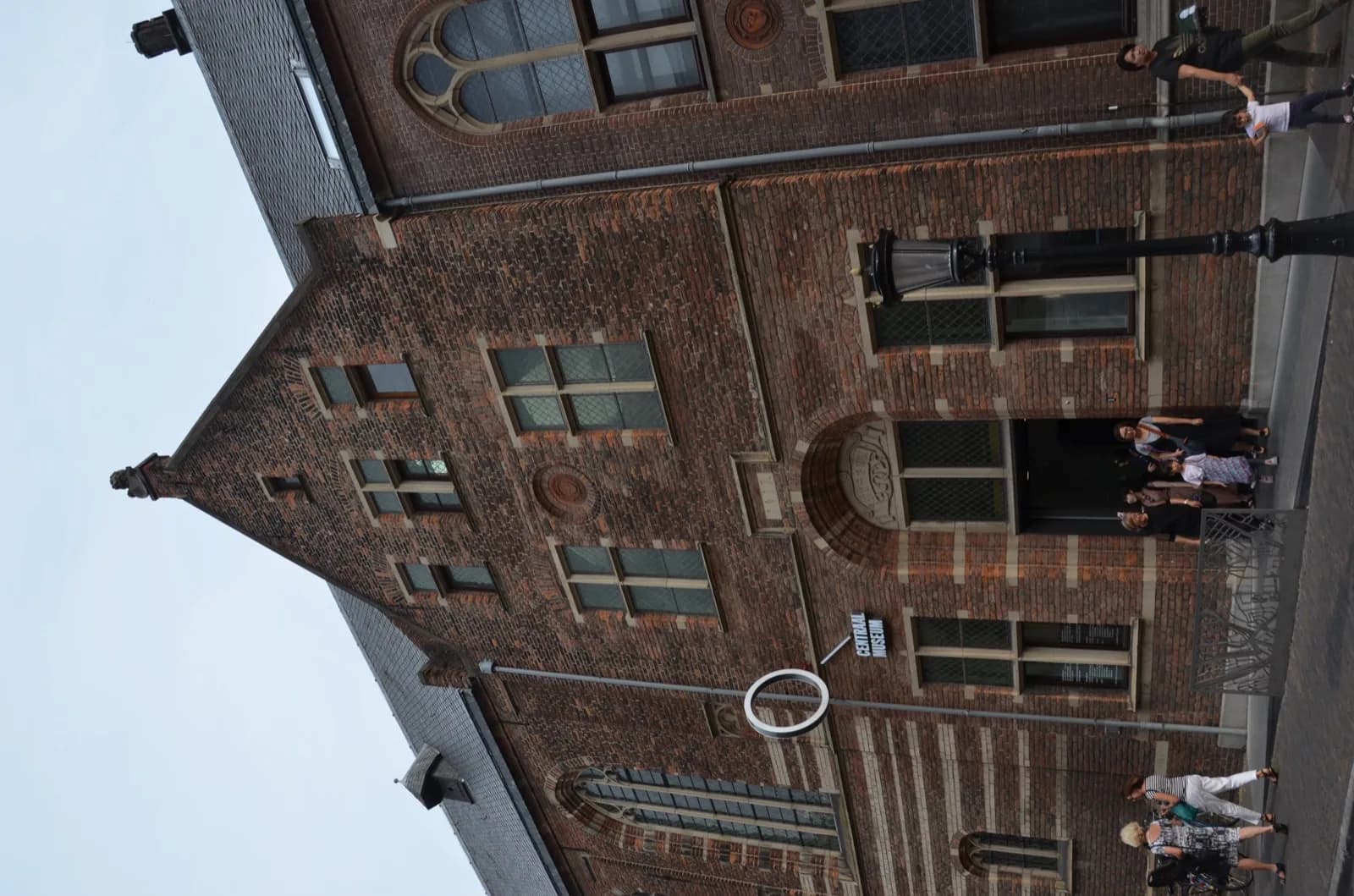 The historic brick building of the Centraal Museum in Utrecht, Netherlands, featuring Gothic Revival architecture with arched windows and the museum sign, viewed from the street.