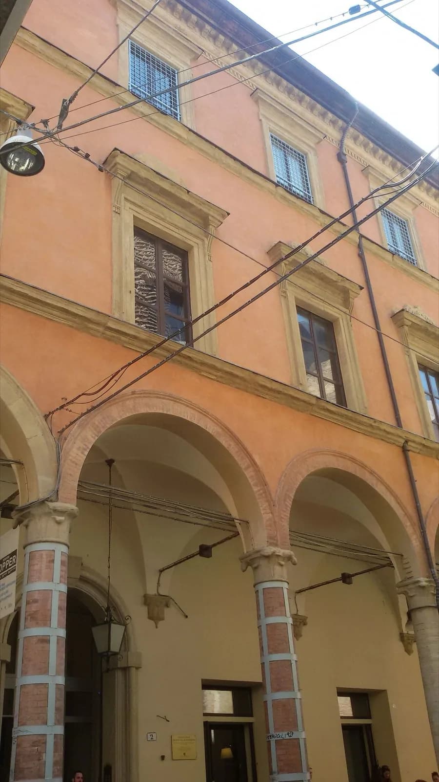 Facade of Palazzo Fava in Bologna, a historic Renaissance palace with arched windows, balconies and decorative elements on Via Manzoni, Bologna, Italy.