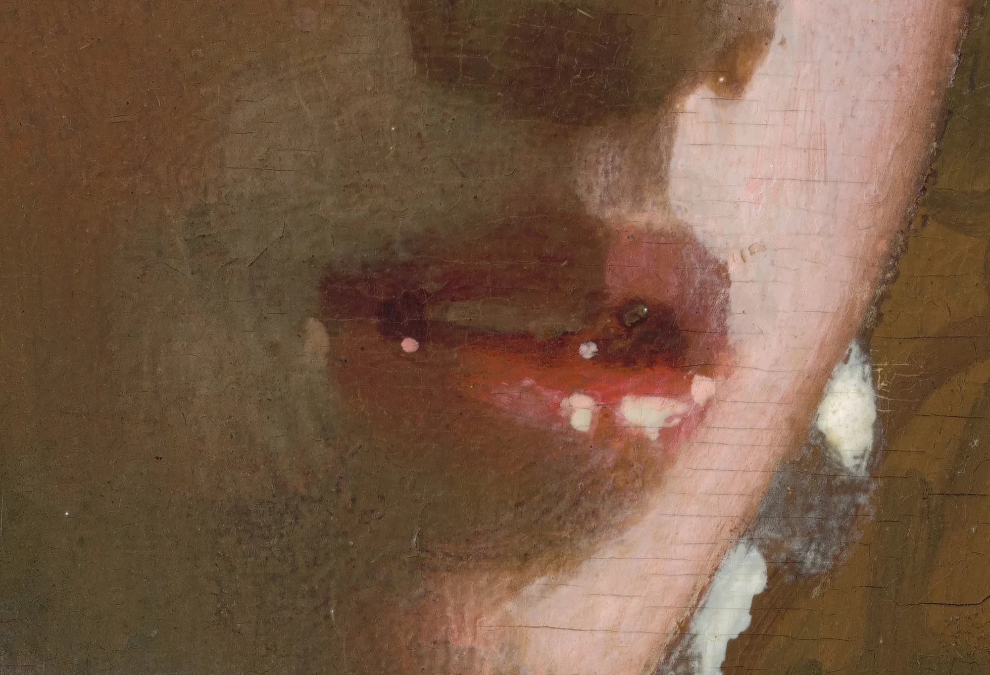 Detail of the model's moist, parted lips touched with dabs of light