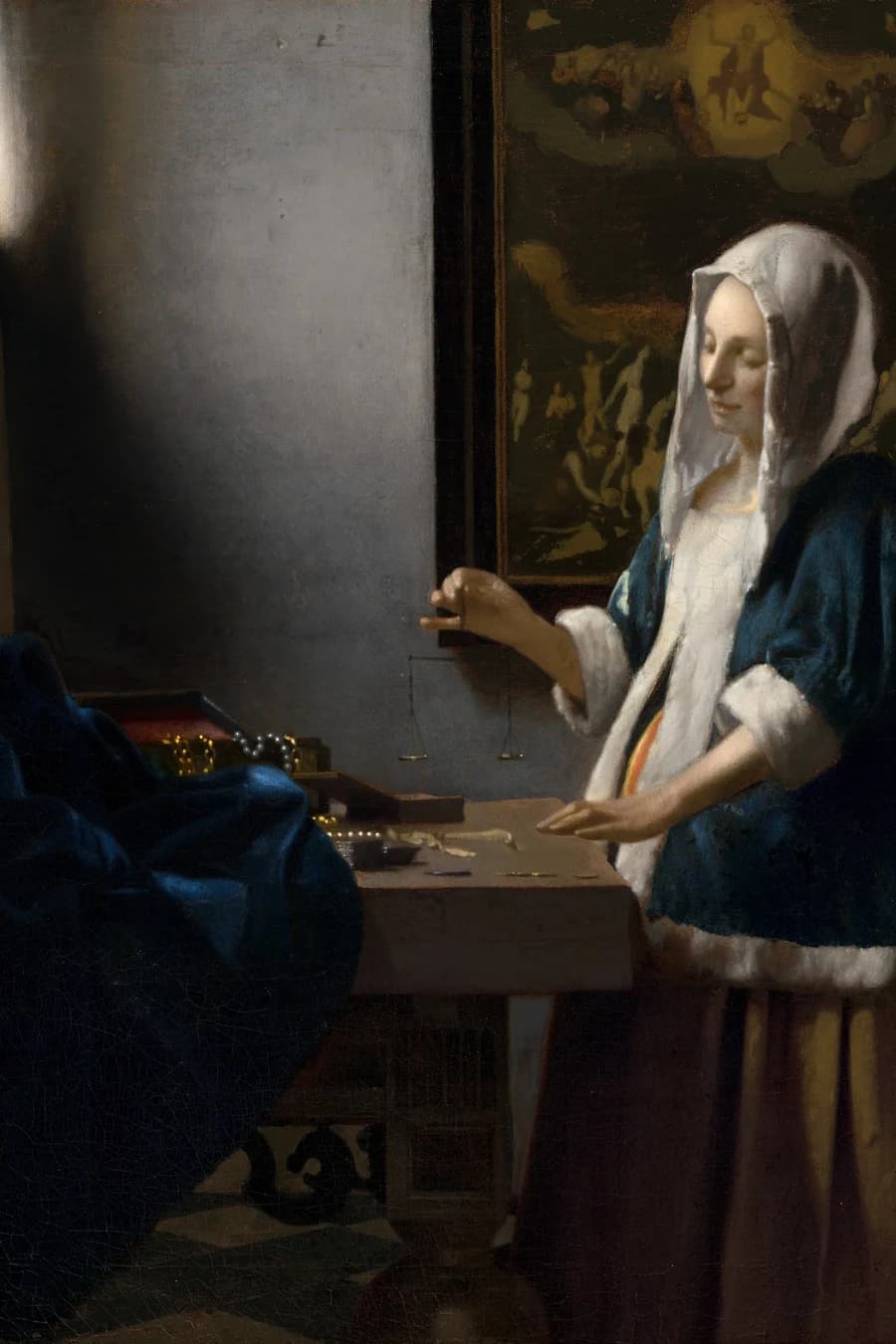 A painting of the Last Judgment hangs on the wall behind the woman in Vermeer's Woman Holding a Balance
