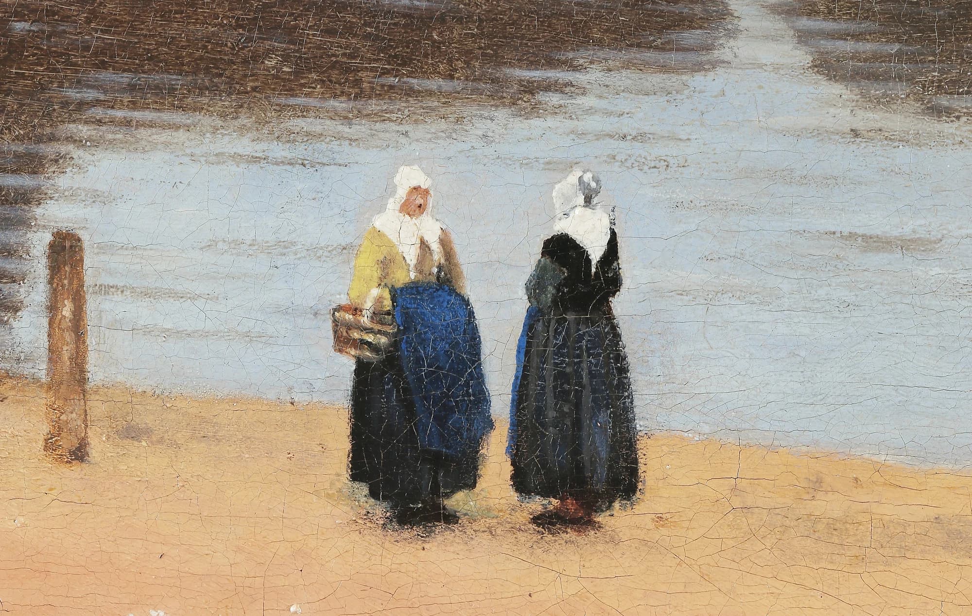 Detail of two women in white caps standing on the sandy near bank, one in a yellow bodice with a basket, the other in a dark skirt