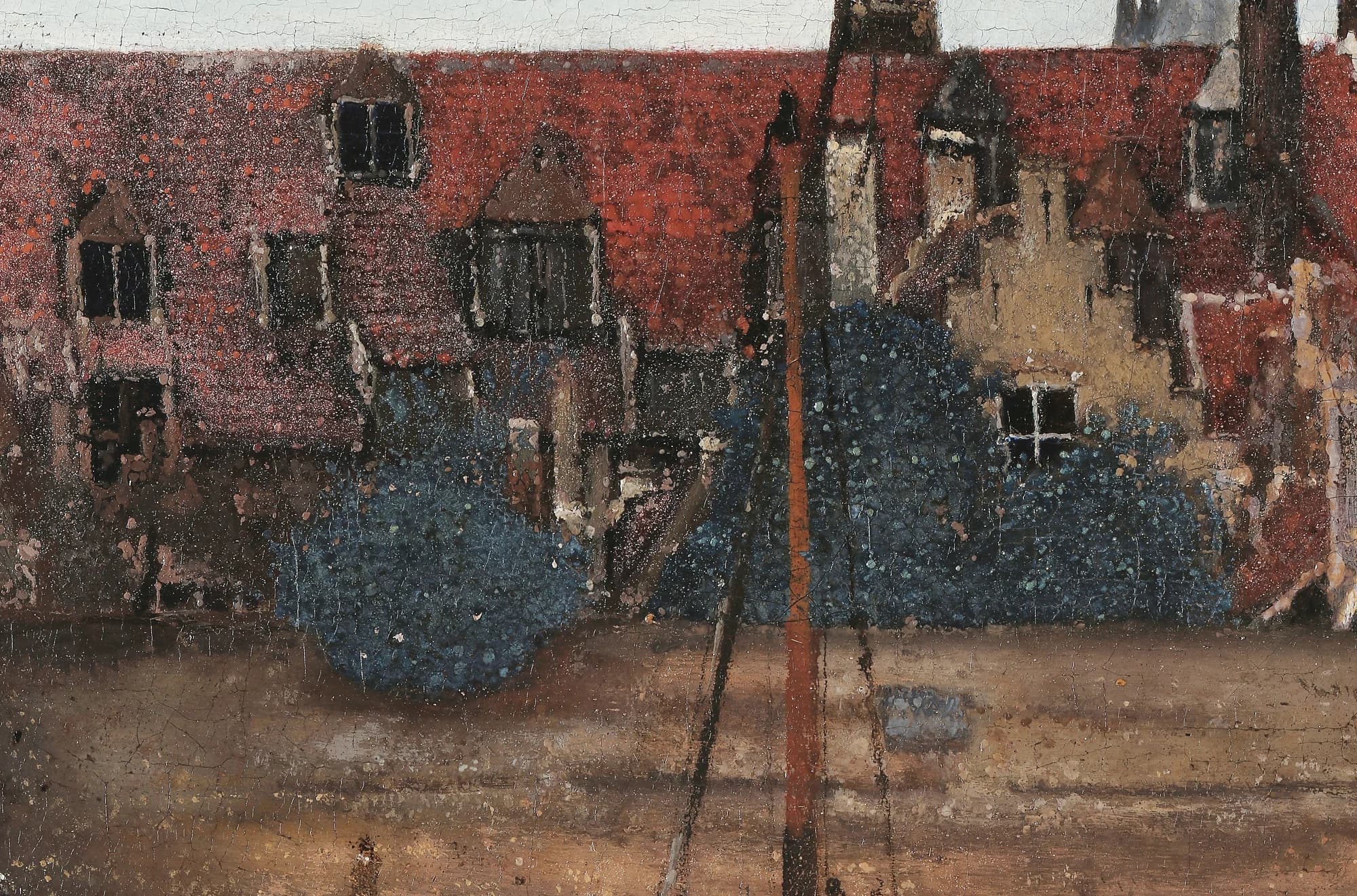 Detail of the red-tiled roofs on the far bank, their surface broken into a grainy, granular texture of pale flecks
