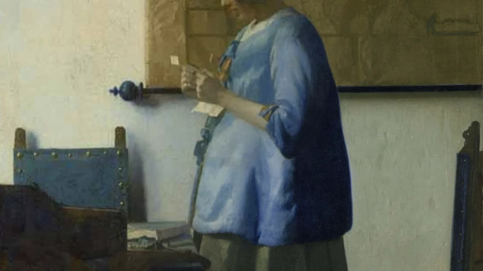 Woman in Blue Reading a Letter by Johannes Vermeer, the same view blended diagonally from the yellowed pre-cleaning state at the upper left into the cleaned painting at the lower right