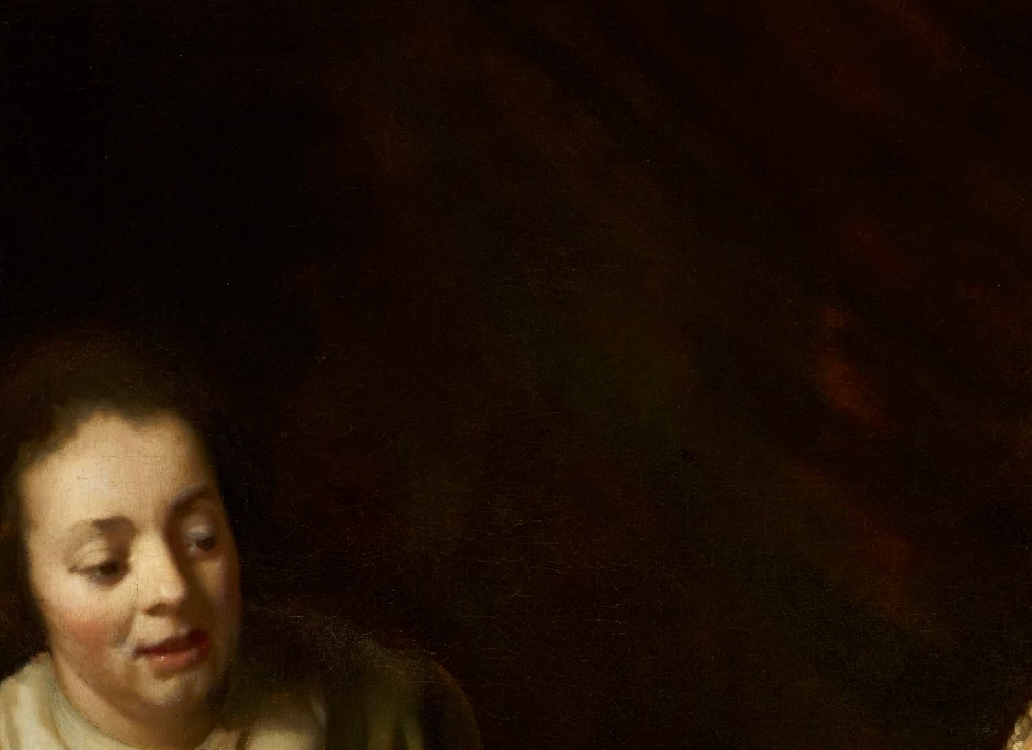 The maid's face at lower left, with the dark brown void above and behind her where the scans found buried figures