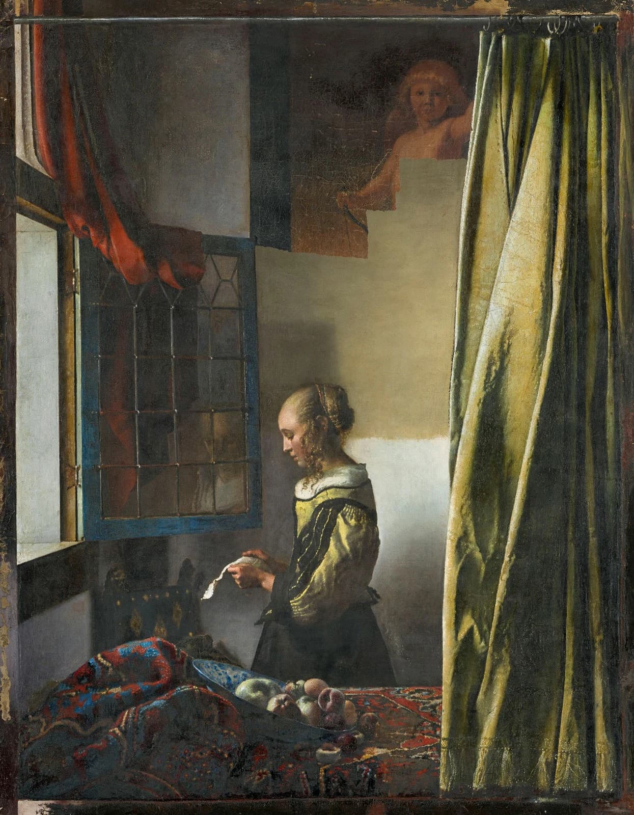 Girl Reading a Letter at an Open Window photographed mid-restoration, the overpaint partly removed so the Cupid is beginning to emerge on the back wall