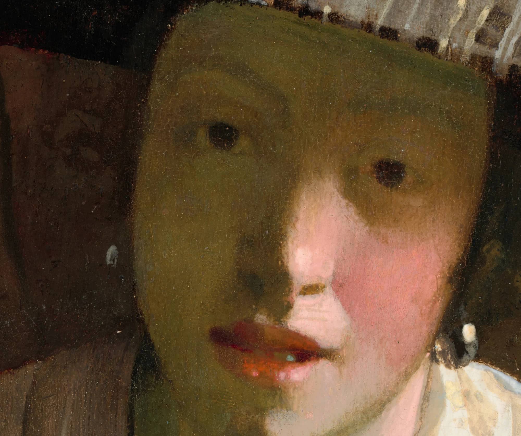Detail of the face in Girl with a Flute, the shadow flat and heavy and the highlights laid on as hard planes